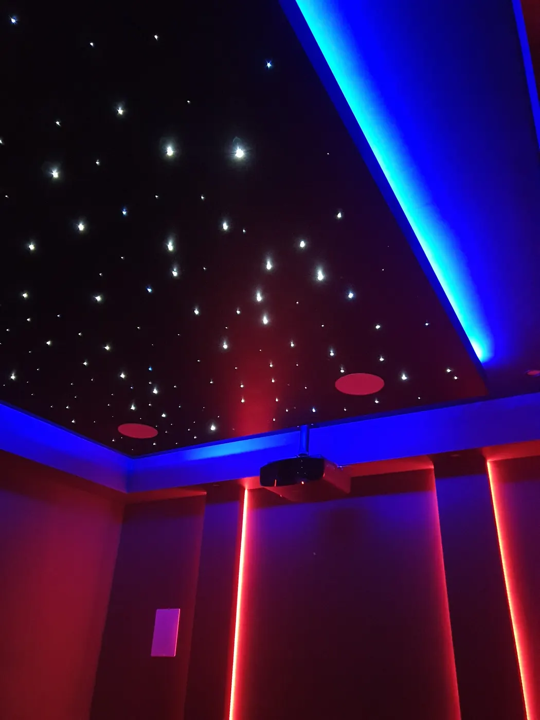 Red and blue lit theatre with shooting-star ceiling