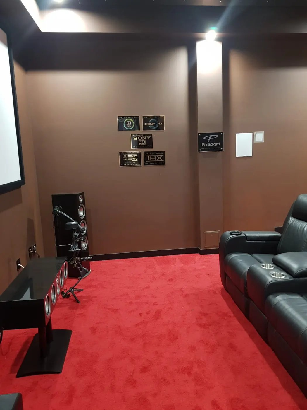 Dedicated home theatre with projection screen and floor-standing speakers