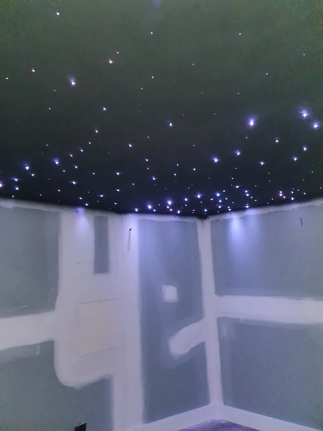 Star ceiling lit up during installation, before walls are finished