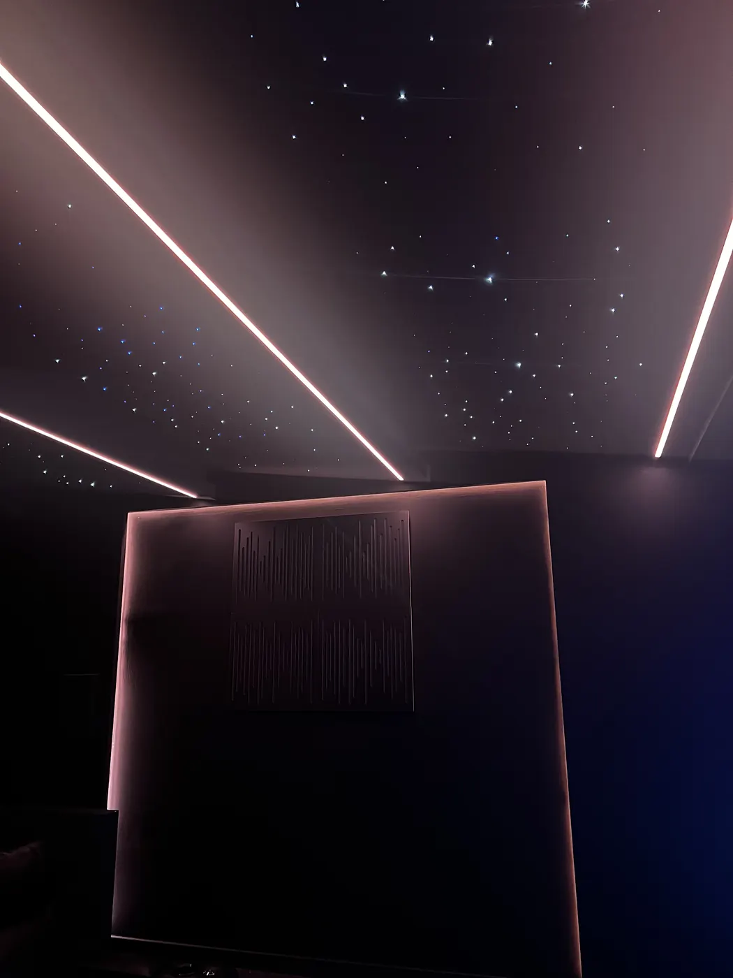 Star ceiling with warm light lines and acoustic panel